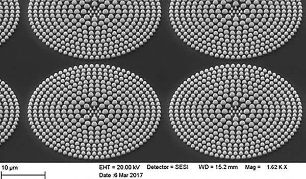 
        Scanning electron microscope (SEM) image of four flat lenses fabricated on GaSb substrates. The lens diameter is 30 microns and focal length is estimated to be 100 microns. 
    
