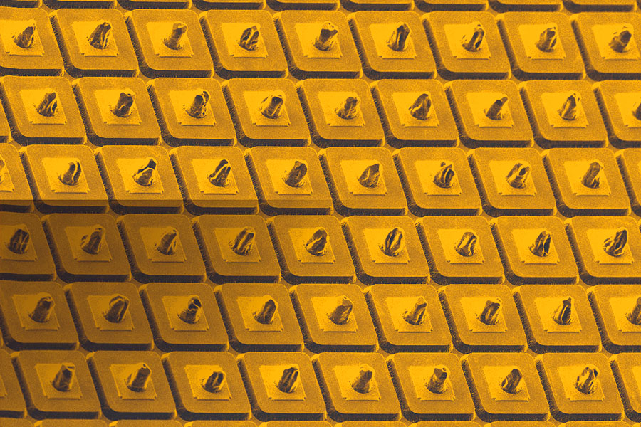 
       Detector Array: A scanning electron microscope (SEM) image of a part of a detector array; each square is 20µm x 20µm. Indium bumps have been deposited on the individual delineated detector pixels to facilitate hybridization with silicon readout integrated circuit (ROIC) for imaging focal plane array (FPA) fabrication.
    